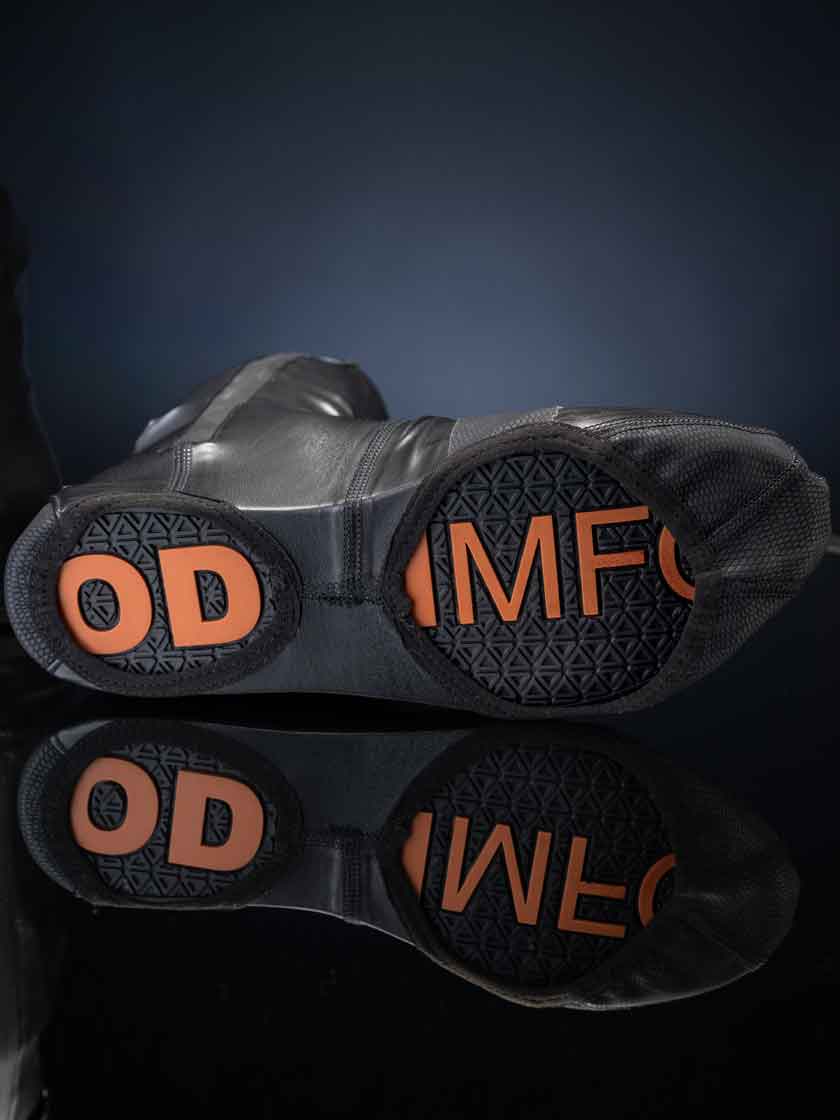 Underside of Odin Mfg motorcycle boot covers showing open-sole design with exposed footwear at heel and forefoot