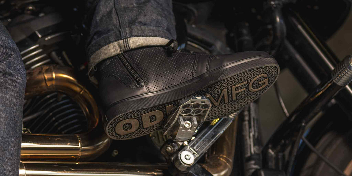 Black perforated motorcycle riding shoe on motorcycle