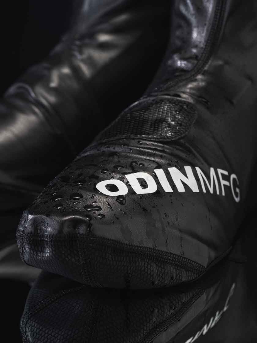 Close-up of Odin Mfg motorcycle rain boot cover showing waterproof upper and textured toe reinforcement